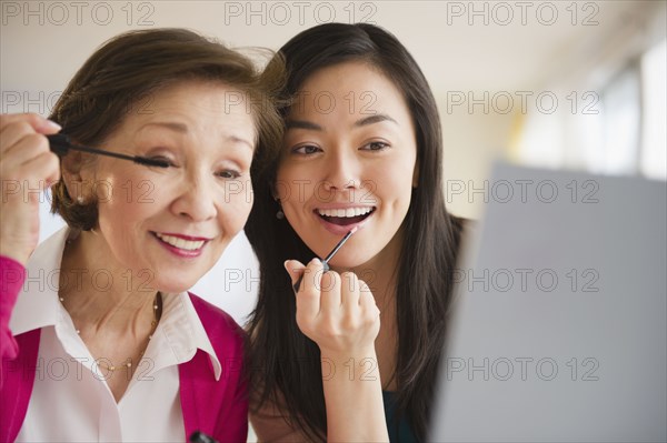 Japanese mother and daughter putting on makeup