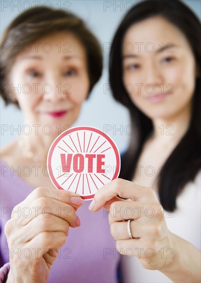 Japanese mother and daughter holding vote sticker