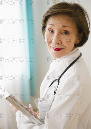 Japanese doctor holding medical chart