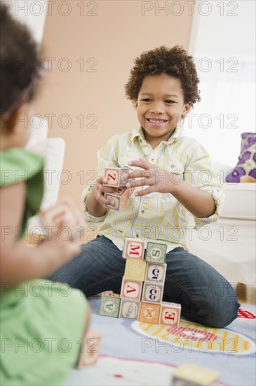 Black brother and sister playing with blocks