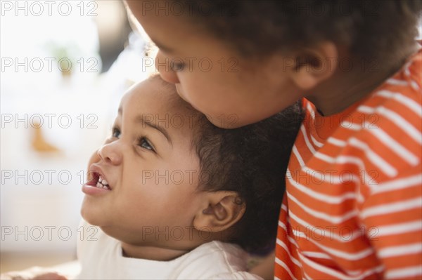 Black boy hugging sister