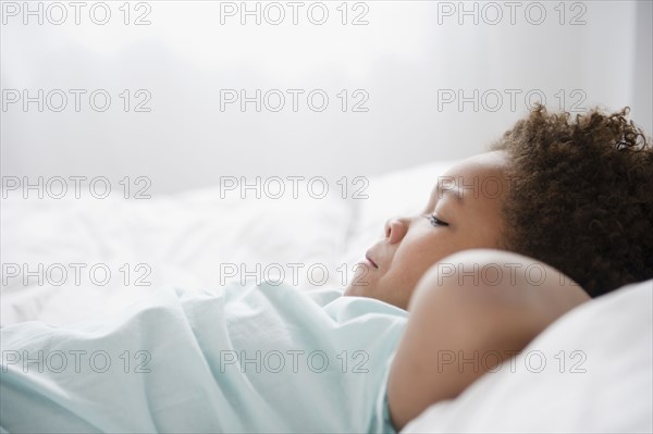 Black boy laying on bed