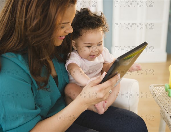 Mixed race mother and baby using digital tablet