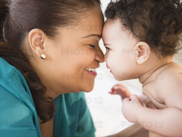 Mixed race mother holding baby