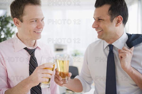 Businessmen toasting with beer