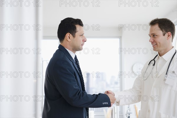 Businessman shaking hands with doctor