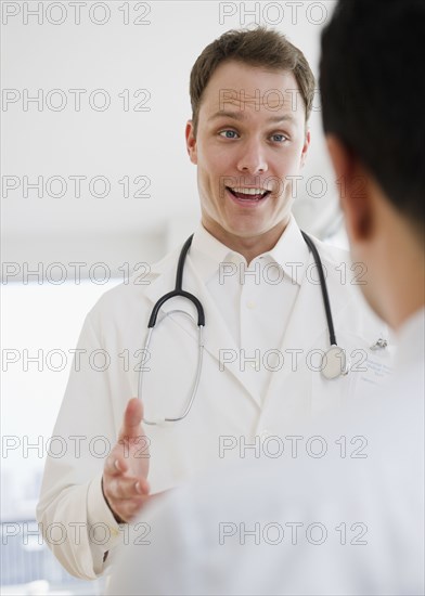 Caucasian doctor talking to co-worker
