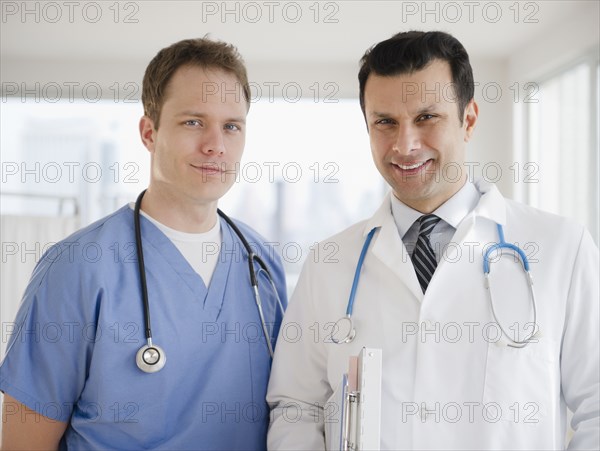 Smiling doctor and surgeon in hospital