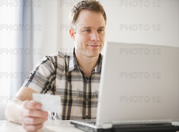 Caucasian man shopping online with credit card