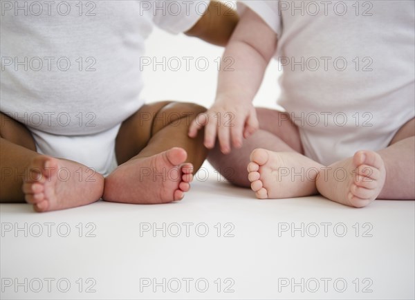 Babies sitting on floor