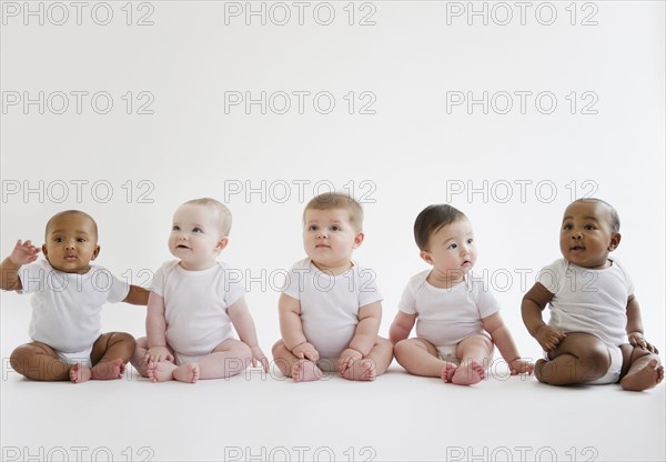 Babies sitting on floor together