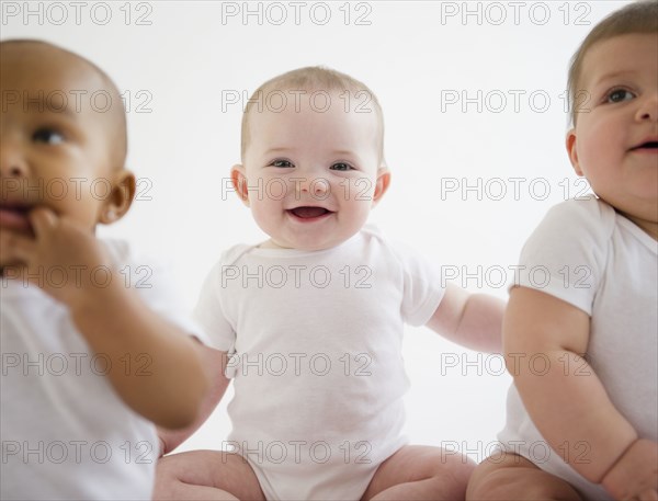 Smiling babies sitting together