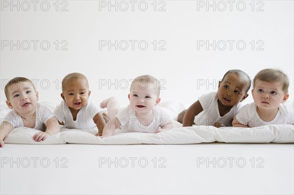 Babies laying on floor together