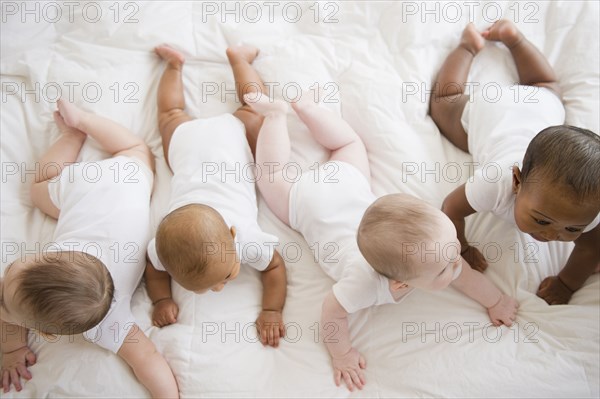 Babies laying on floor together