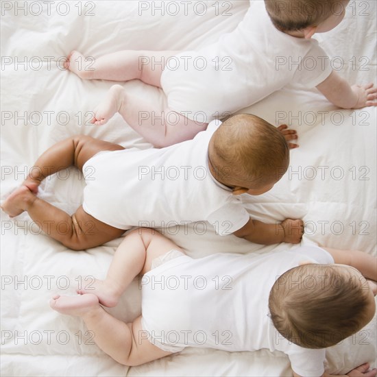 Babies laying on floor together