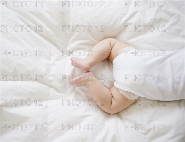 Mixed race baby boy laying on floor