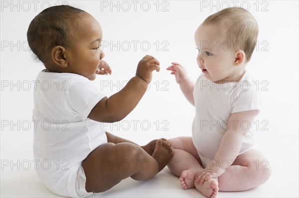 Babies playing together on floor