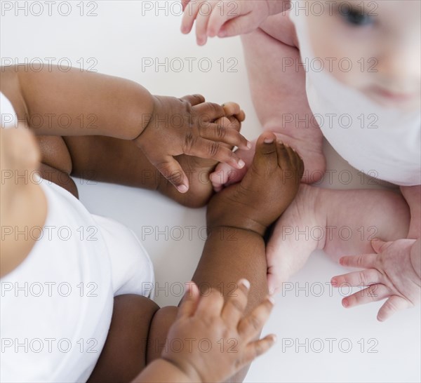 Babies sitting together on floor