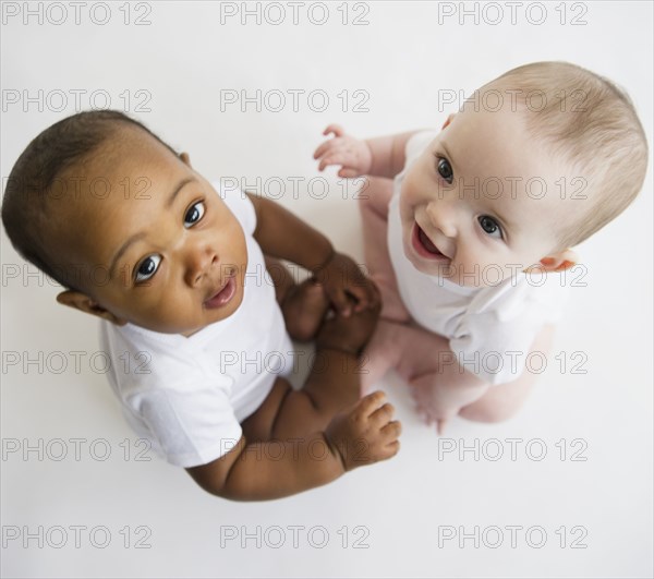 Babies sitting together on floor