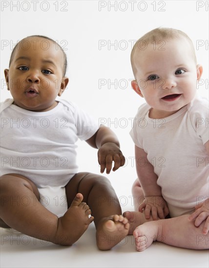 Babies sitting together on floor