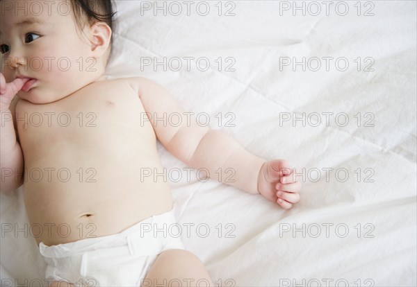 Asian baby girl laying on blanket