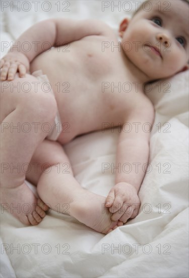 Caucasian baby girl laying on blanket