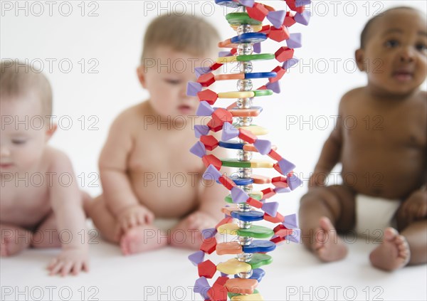 Babies sitting with DNA helix