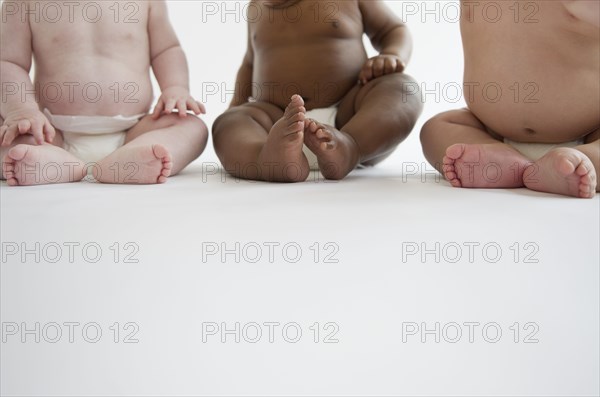 Babies sitting on floor together