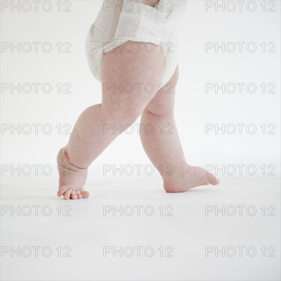 Caucasian baby girl walking