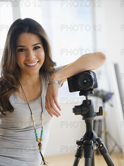 Hispanic woman leaning on camera