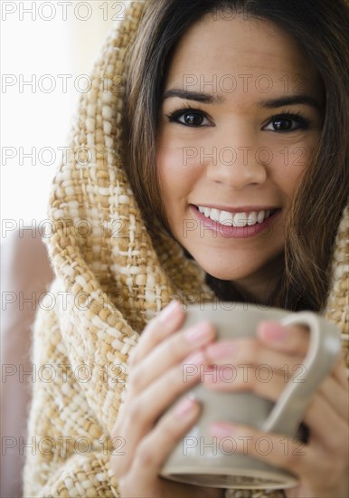 Hispanic woman drinking coffee