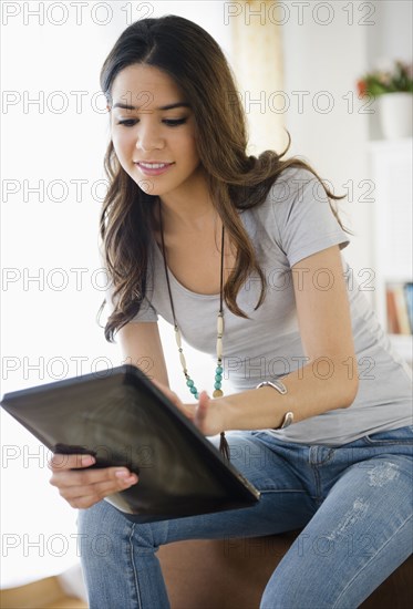 Hispanic woman using digital tablet