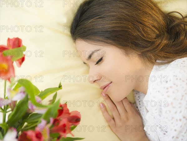 Hispanic woman sleeping in bed