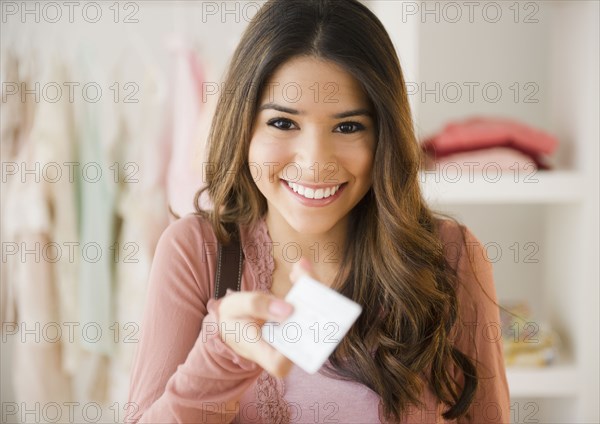 Hispanic woman shopping with credit card