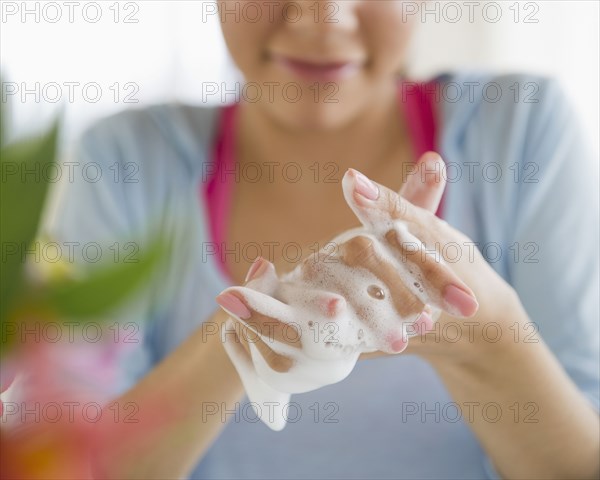 Hispanic woman washing hands