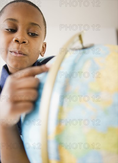 Black boy looking at globe