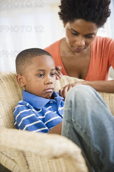 Black mother comforting son