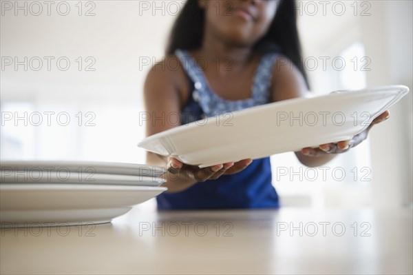 Black girl setting the table