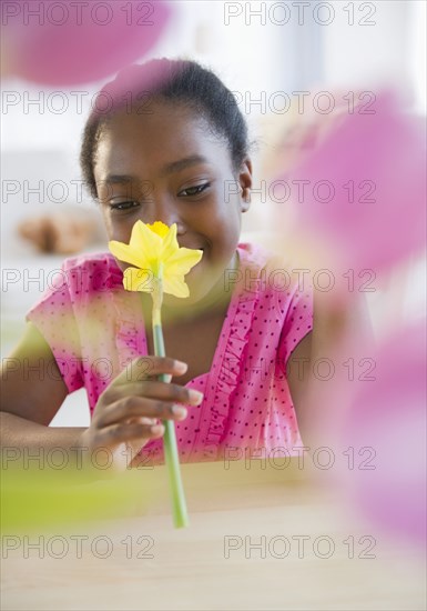 Black girl smelling flower