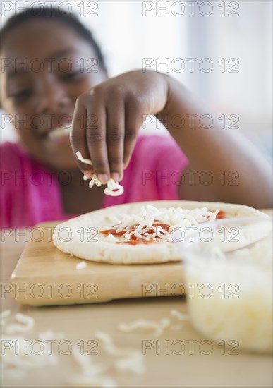Black girl making pizza