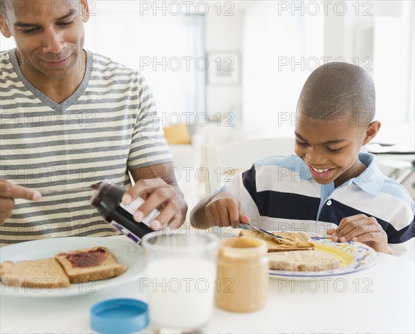 Father and son eating breakfast together