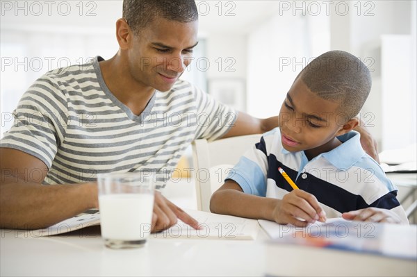 Father helping son with homework