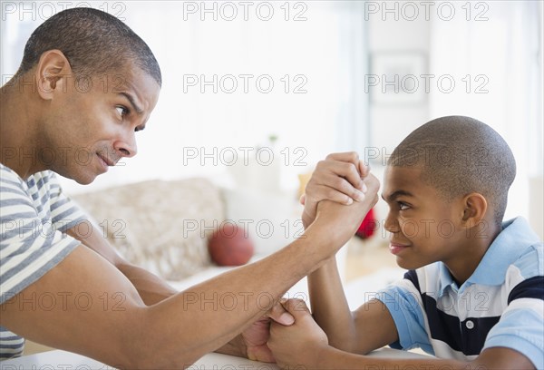 Father and son arm wrestling