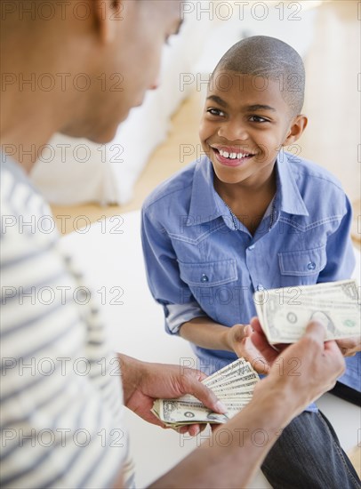 Father giving son money