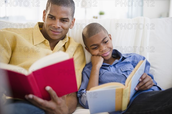Father and son reading books