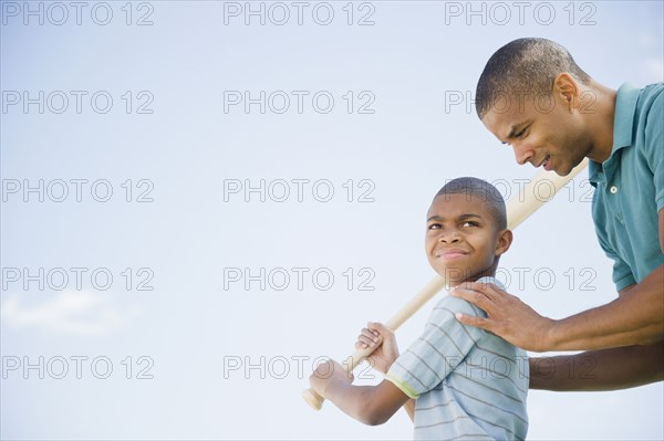 Father teaching son to play baseball