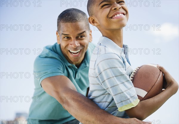 Father and son playing football