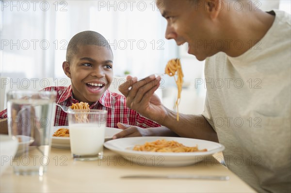 Father and son eating dinner