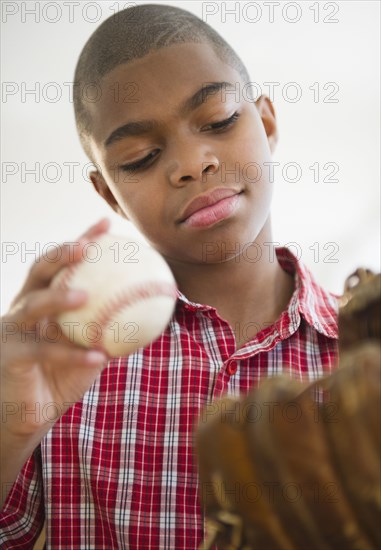 African American boy holding baseball