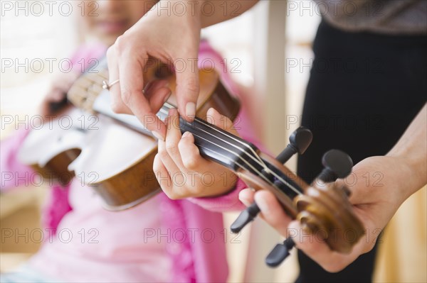 Mixed race girl learning to play violin